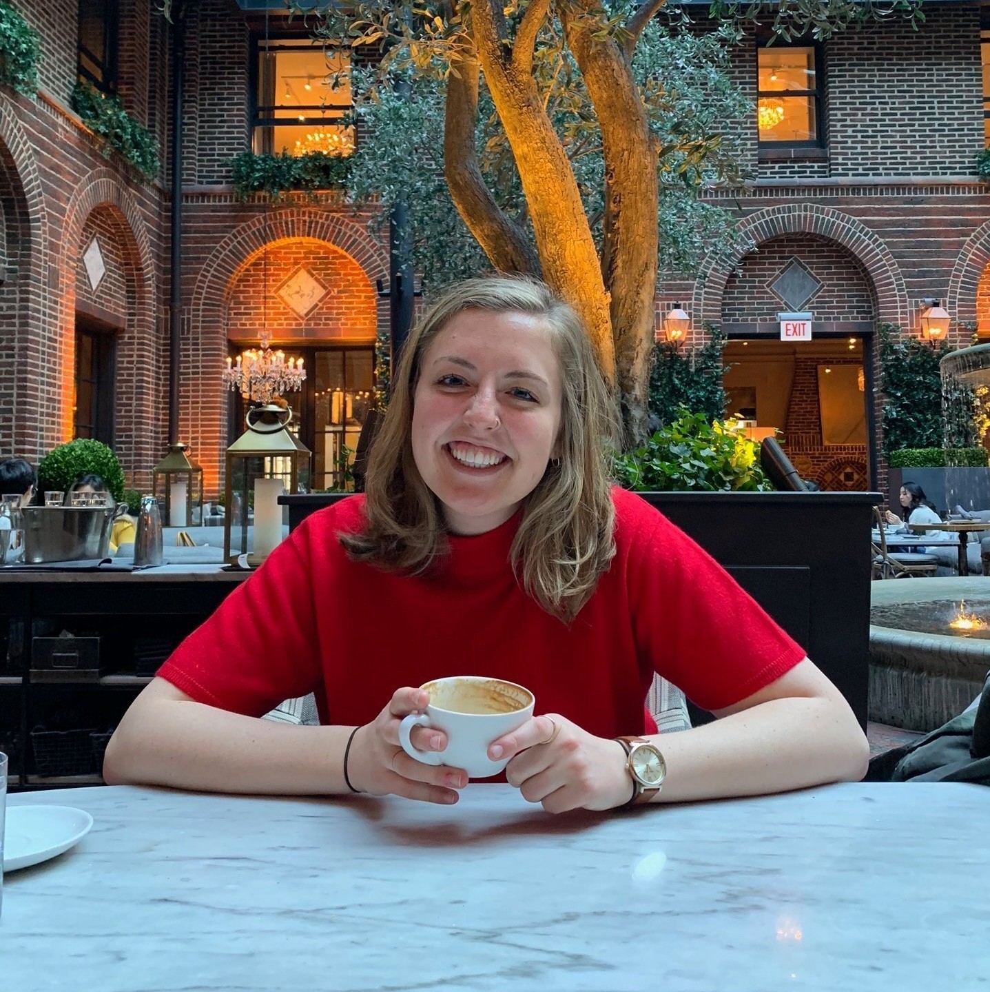 Grace Bobber enjoys a coffee and smiles at the camera